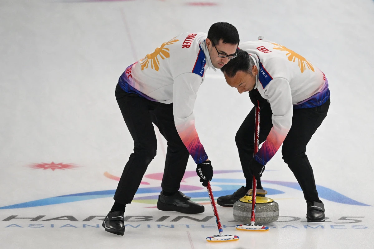 Philippines’ Christian Haller (L) and Alan Frei sweep during the men’s curling round robin group A session 5 between the Philippines and Kazakhstan during the Harbin 2025 Asian Winter Games in Harbin, northeast China’s Heilongjiang province on Feb. 10, 2025. (AFP)