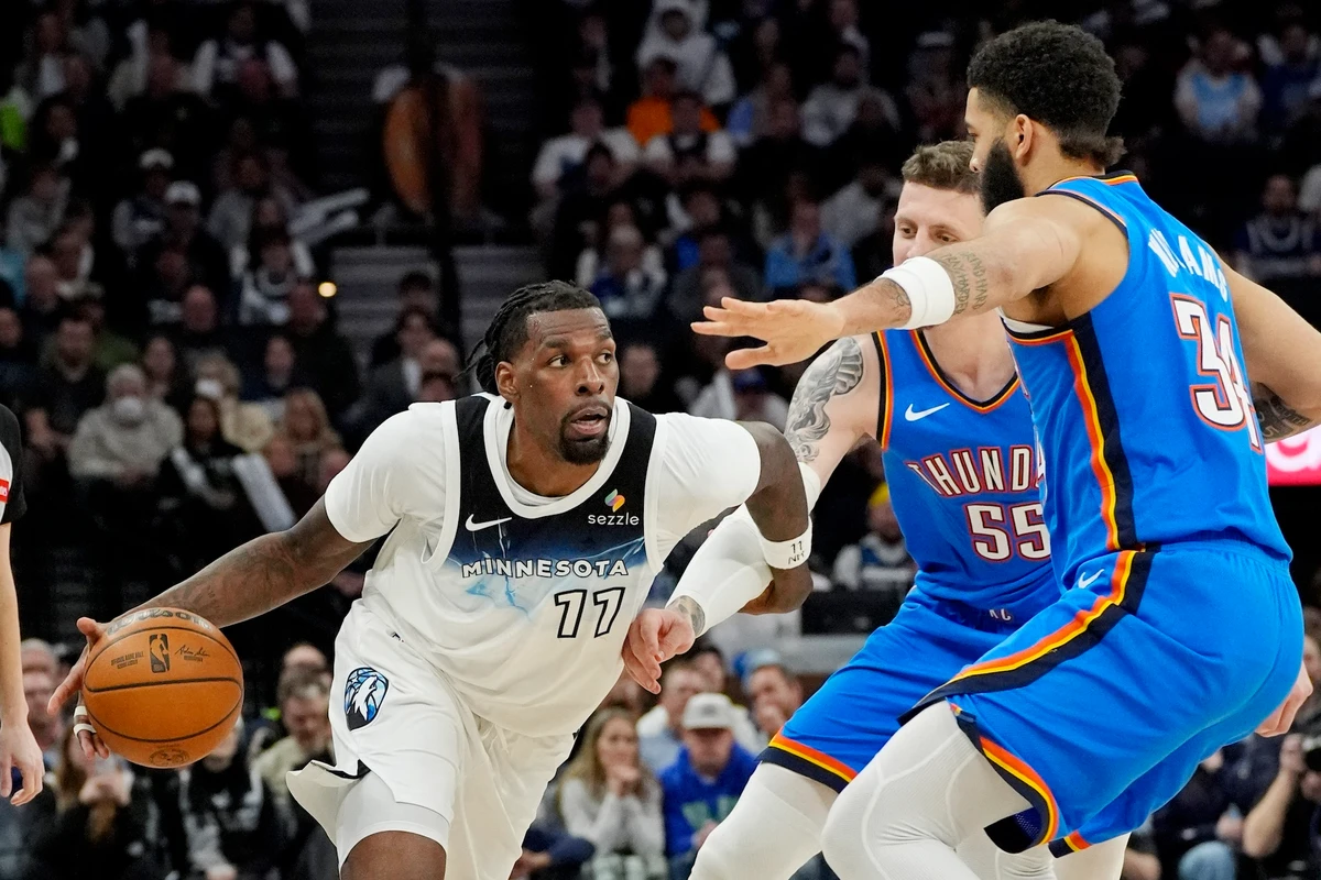 Minnesota Timberwolves center Naz Reid dribbles around Oklahoma City Thunder center Isaiah Hartenstein (55) and guard Kenrich Williams in the fourth quarter of an NBA Game at Target Center Thursday. (USA TODAY Sports)