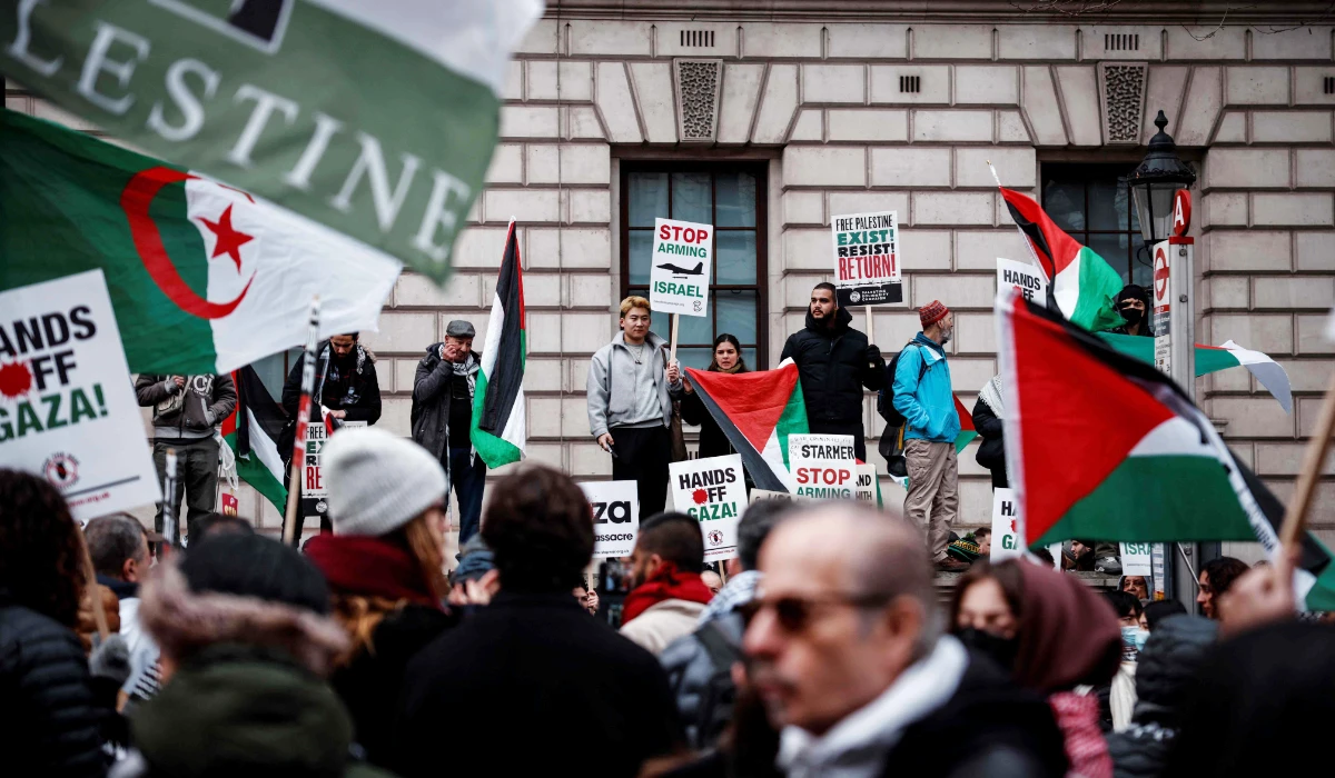 Protesters hold placards and wave Palestinian flags as they take part in a Pro-Palestinian march in central London, on February 15, 2025, organised by the Palestine Solidarity Campaign. (AFP)