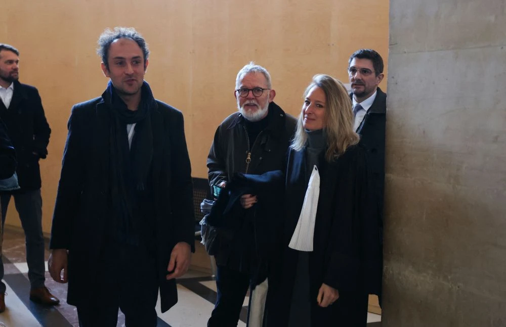 Didier Francois, center, and Edouard Elias leave, during a break, on the first day of the trial of five men for holding French journalists hostage in Syria in 2013, Paris, France, Feb. 17, 2025. (AFP)