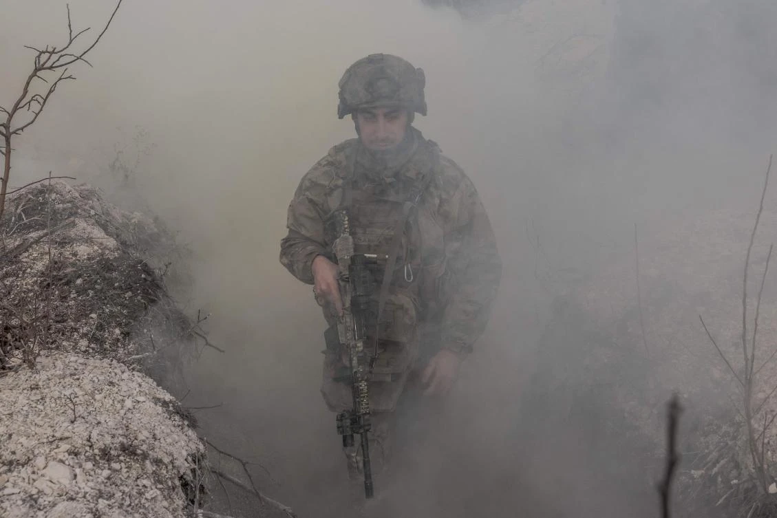 A Ukrainian military instructor of the Azov Brigade walks through a trench during a military training exercise in the eastern Donetsk region, on February 3, 2025, amid the Russian invasion of Ukraine. (AFP)