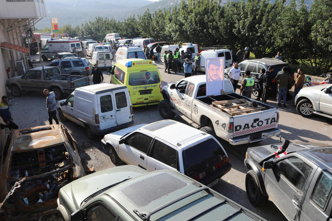 Civil defense members gather at the entrance of Deir Mimas as they seek to enter the Lebanese southern village of Kfar Kila, Lebanon on Feb. 18, 2025. (Reuters)