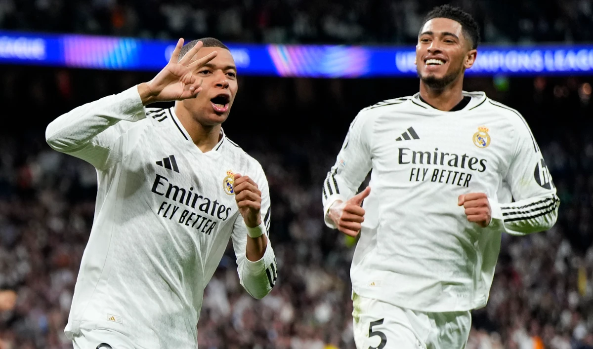 Real Madrid's Kylian Mbappe celebrates with Real Madrid's Jude Bellingham, right, after scoring his sides third goal during the Champions League playoff second leg soccer match between Real Madrid and Manchester City at the Santiago Bernabeu Stadium in Madrid, Spain, Wednesday, Feb. 19, 2025. (AP)