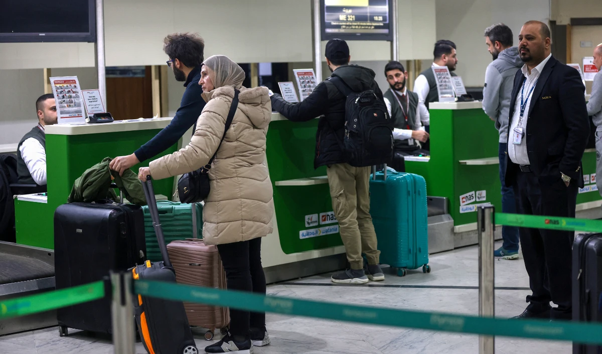 People line up to check in for a flight to Beirut at the Baghdad International Airport. Flights are nearly at capacity as airlines increase services. (AFP)