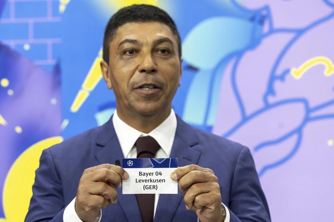 Brazilian former player Giovane Elber shows the ticket of German club Bayer 04 Leverkusen, during the UEFA Champions League round of 16, quarter-final and semifinal draws, at the UEFA headquarters in Nyon, Feb. 21, 2025. (AP)