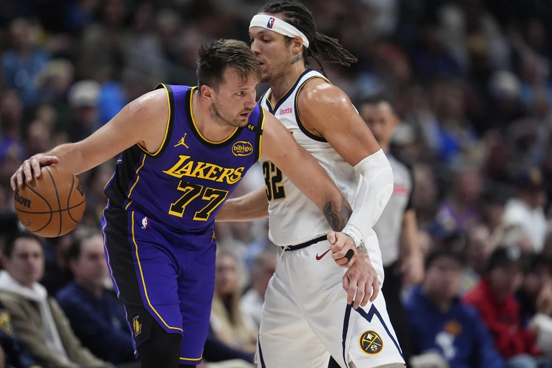 Los Angeles Lakers guard Luka Doncic, left, drives past Denver Nuggets forward Aaron Gordon in the second half of their NBA game on Feb. 22, 2025 in Denver. (AP)