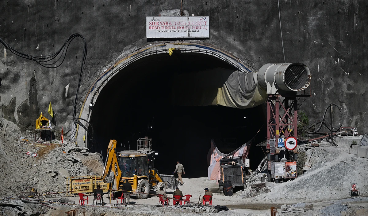 Police sit at the entrance of the under construction Silkyara tunnel in the Uttarkashi district of India's Uttarakhand state on November 29, 2023, a day after rescue teams safely brought out all the workers from the collapsed Himalayan road tunnel. (AFP/File)