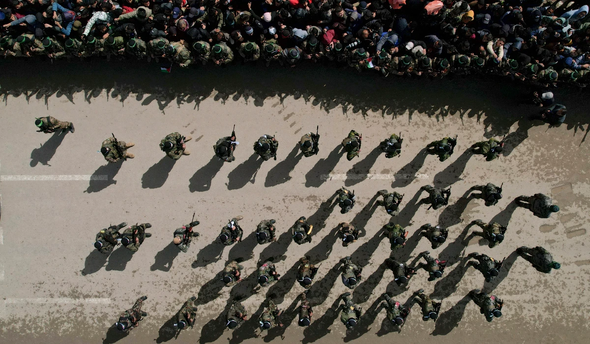 Palestinians gather as Hamas fighters deploy ahead of the planned release of Israeli hostages set to be handed over to the Red Cross in Nuseirat, Gaza Strip Saturday, Feb. 22, 2025. (AP)