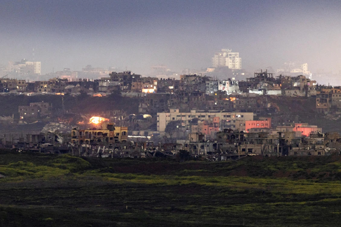 Fires burn to light damaged houses, amid a ceasefire between Hamas and Israel, as seen from the Israeli side of the border, February 24, 2025. (Reuters)