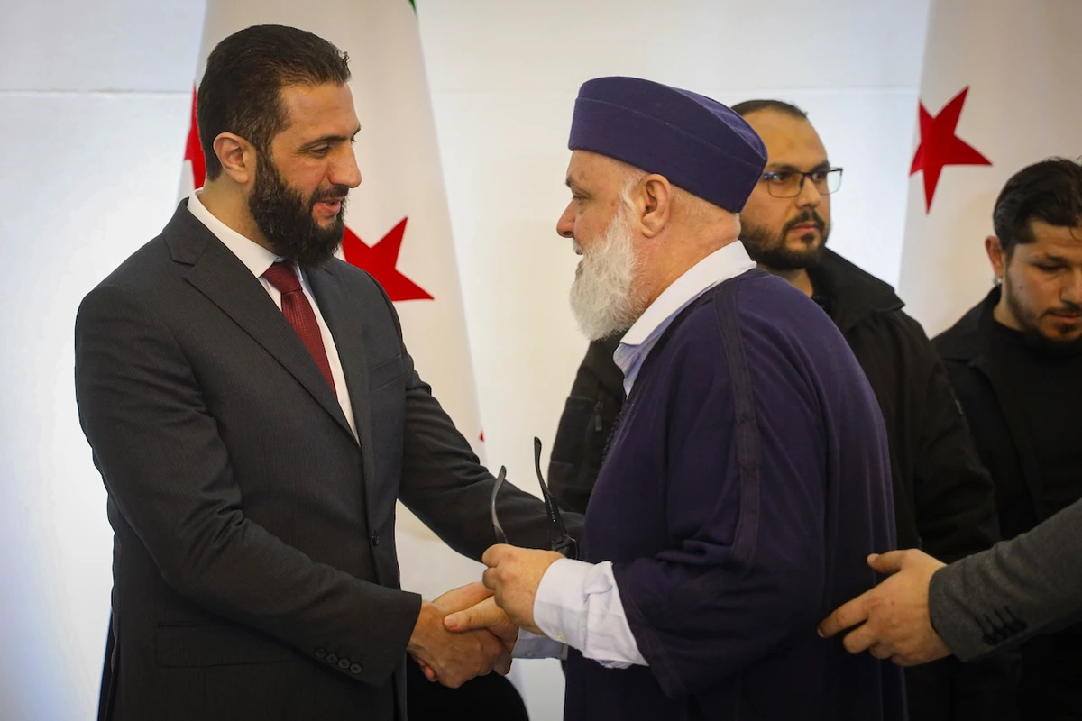 Syrian President Ahmad Al-Sharaa greets delegates during Syria’s national dialogue conference at the People’s Palace in Damascus, Syria, Feb. 25, 2025. (AP)