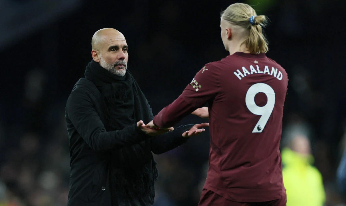 Manchester City manager Pep Guardiola and Erling Haaland celebrate after the Premier League match against Tottenham Hotspur on Wednesday. (Reuters)
