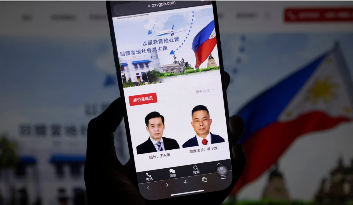 The website of the Qiaoxing Volunteer Group, a Chinese community organization in the Philippines, features photos of Wang Yongyi, left, and Cai Shaohuang, in this illustration picture taken February 27, 2025. (REUTERS)