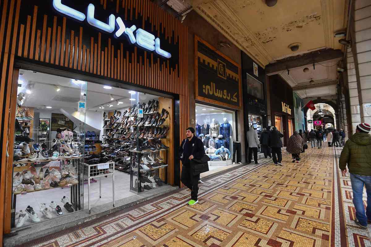Tunisians walk in a commercial area in central Tunis on March 7. (AFP)