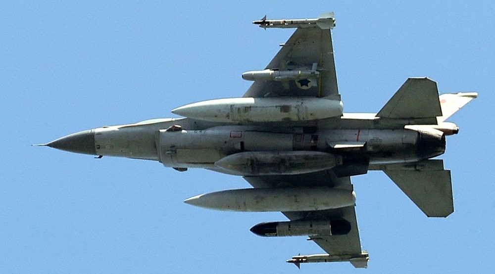An Israeli Air Force F-16 fighter aircraft flies over the city of Yokneam Illit in northern Israel on March 24, 2025. (AFP)