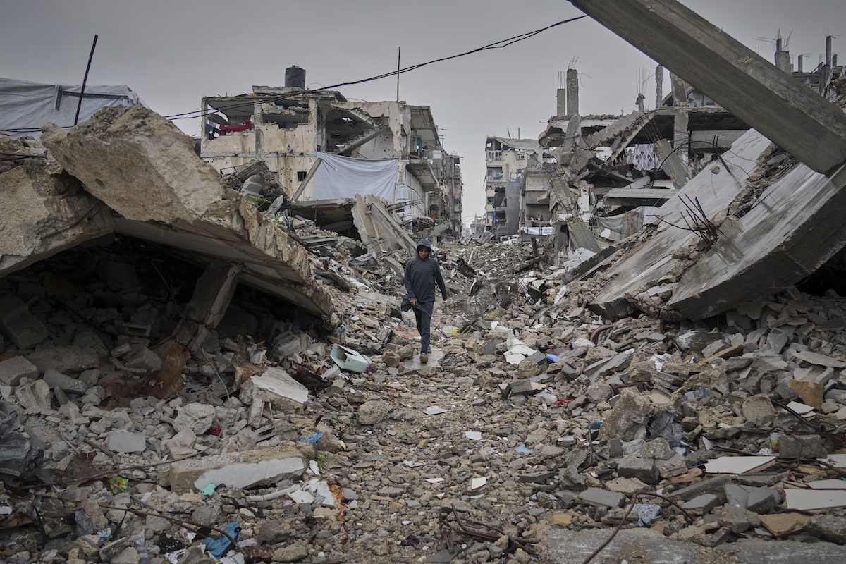 A boy walks down a street covered by the rubble of destroyed homes and buildings in Beit Lahiya, northern Gaza. (AP)