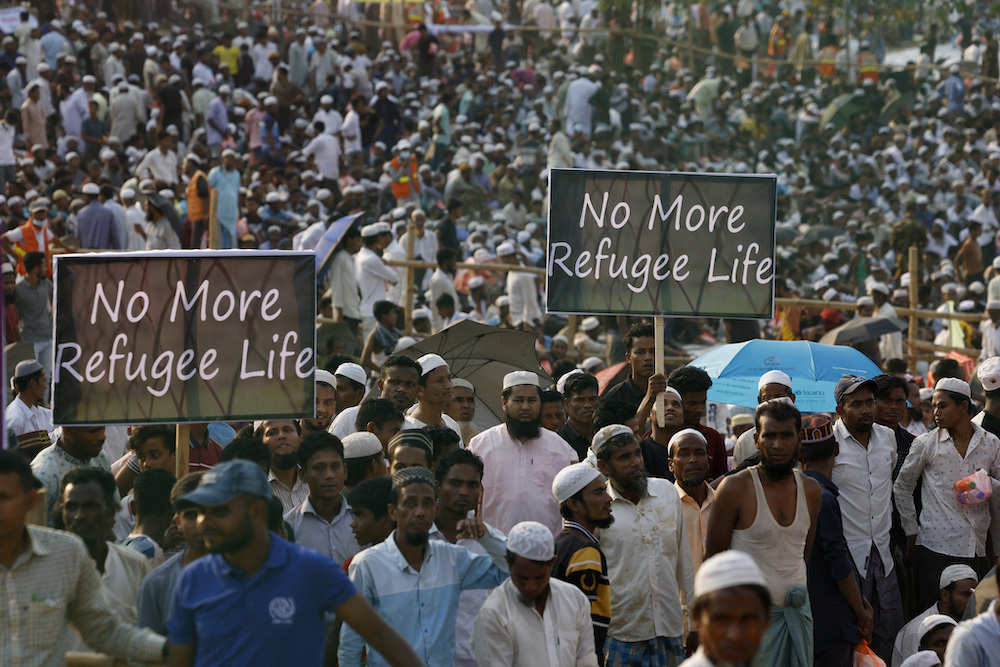 Rohingya refugees hold placards while attending a Ramadan Solidarity Iftar event. (Reuters)
