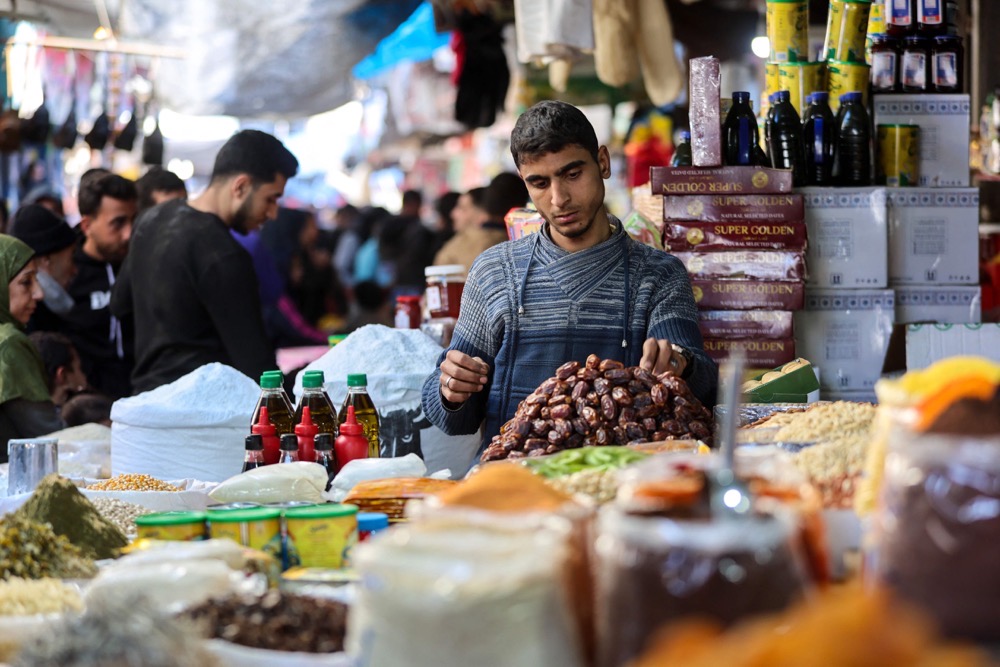 A Palestinian man arranges dates at the old Zawiya market in Gaza City. (AFP)