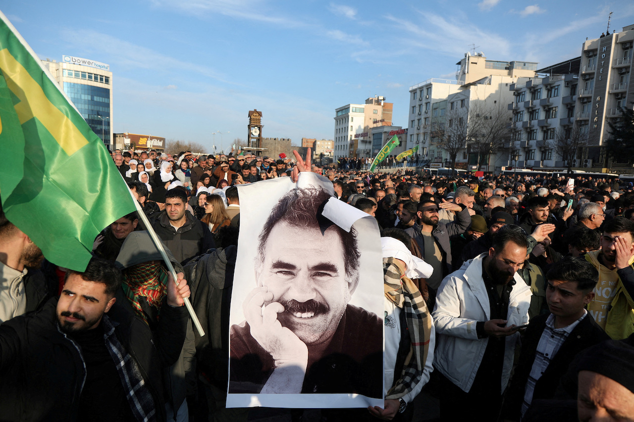 A demonstrator holds a picture of jailed Kurdish militant leader Abdullah Ocalan during a rally in Diyarbakir, Turkey, February 27, 2025. (Reuters)