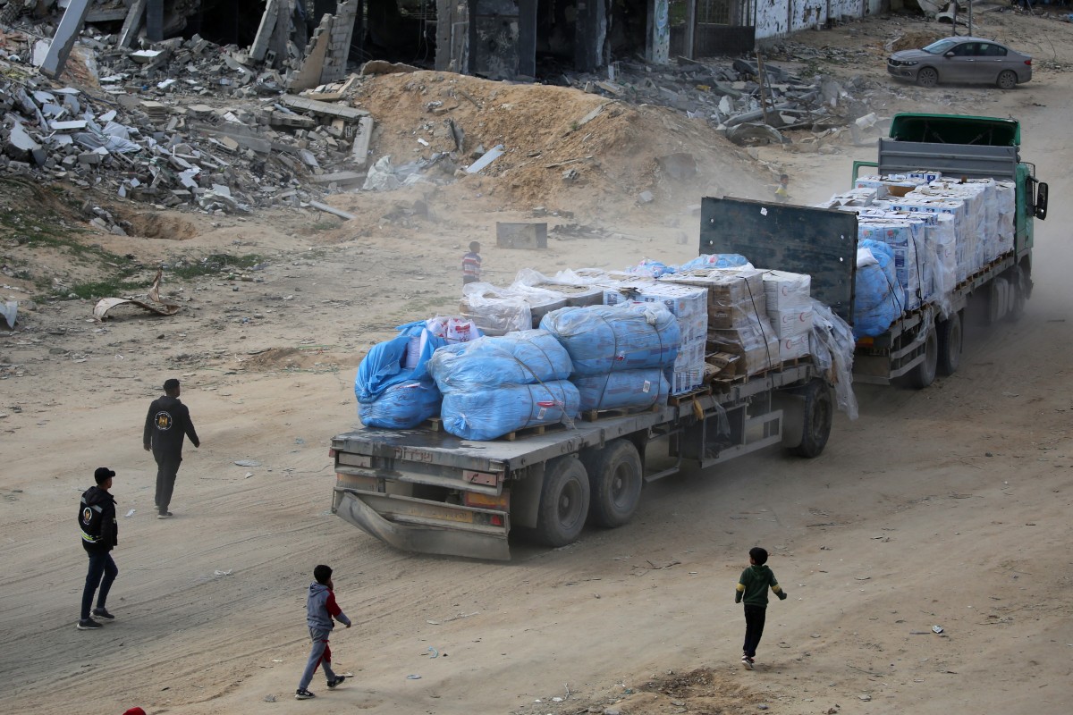 A truck loaded with humanitarian aid drives through Rafah in the southern Gaza Strip after entering from the Kerem Shalom crossing on February 18, 2025 (AFP)