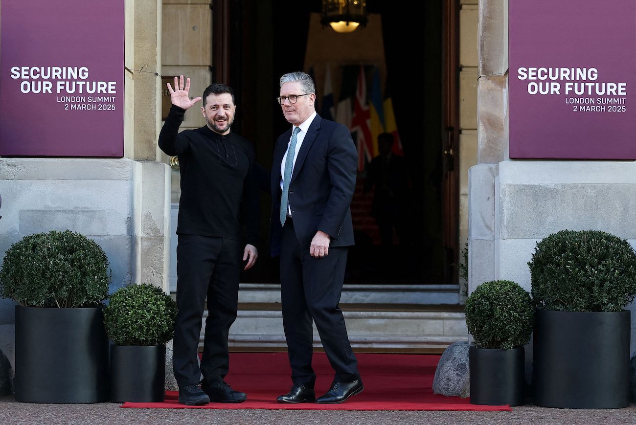 British PM Keir Starmer (R) greets Ukraine’s President Volodymyr Zelensky (L) as he arrives to attend a summit held at Lancaster House in London on March 2, 2025. (AFP)