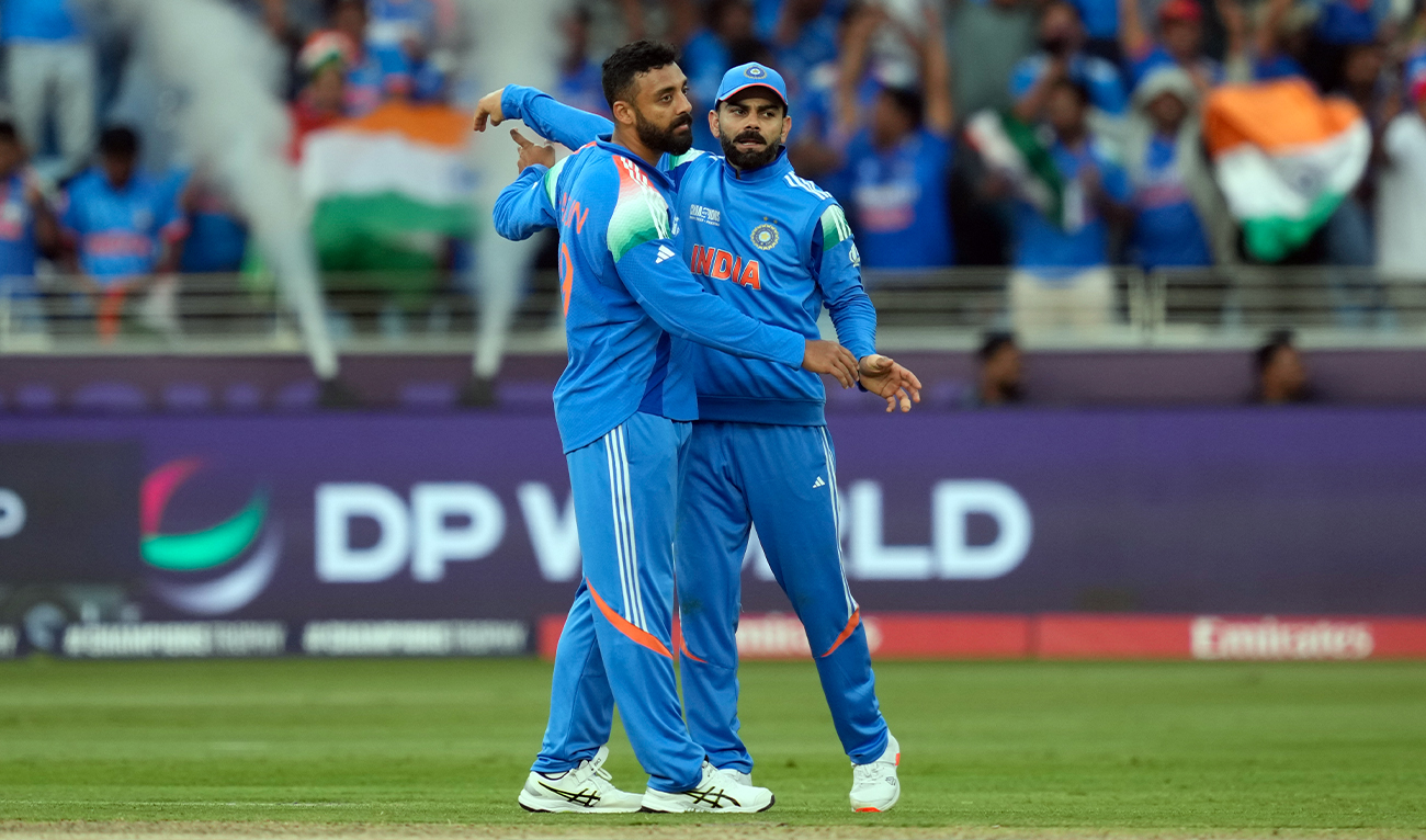 India’s Varun Chakravarthy celebrates the wicket of New Zealand’s Will Young with India’s Virat Kohli (right) during the ICC Champions Trophy cricket match between India and New Zealand at Dubai International Cricket Stadium in Dubai, United Arab Emirates, on March 2, 2025. (AP)