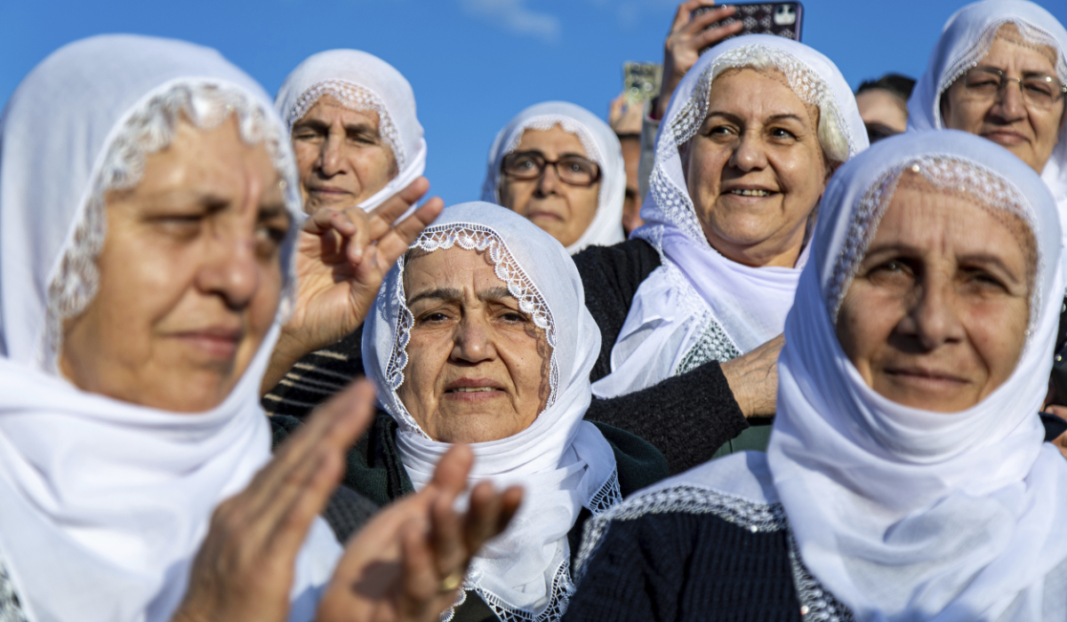 Kurdish women gather to watch live on a tv screen a Pro-Kurdish Peoples' Equality and Democracy Party, or DEM, delegation members releasing an statement from the jailed leader of the rebel Kurdistan Workers' Party, or PKK, Abdullah Ocalan, in Diyarbakir, Turkey, Thursday, Feb. 27, 2025. (AP)