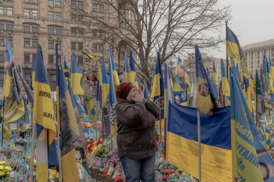 Tetiana reacts as she pays tribute on the birthday day of her son Sergiy Voityshyn, who was killed in 2024 fighting Russian troops in the Donetsk region, March 1, 2025. (AFP)