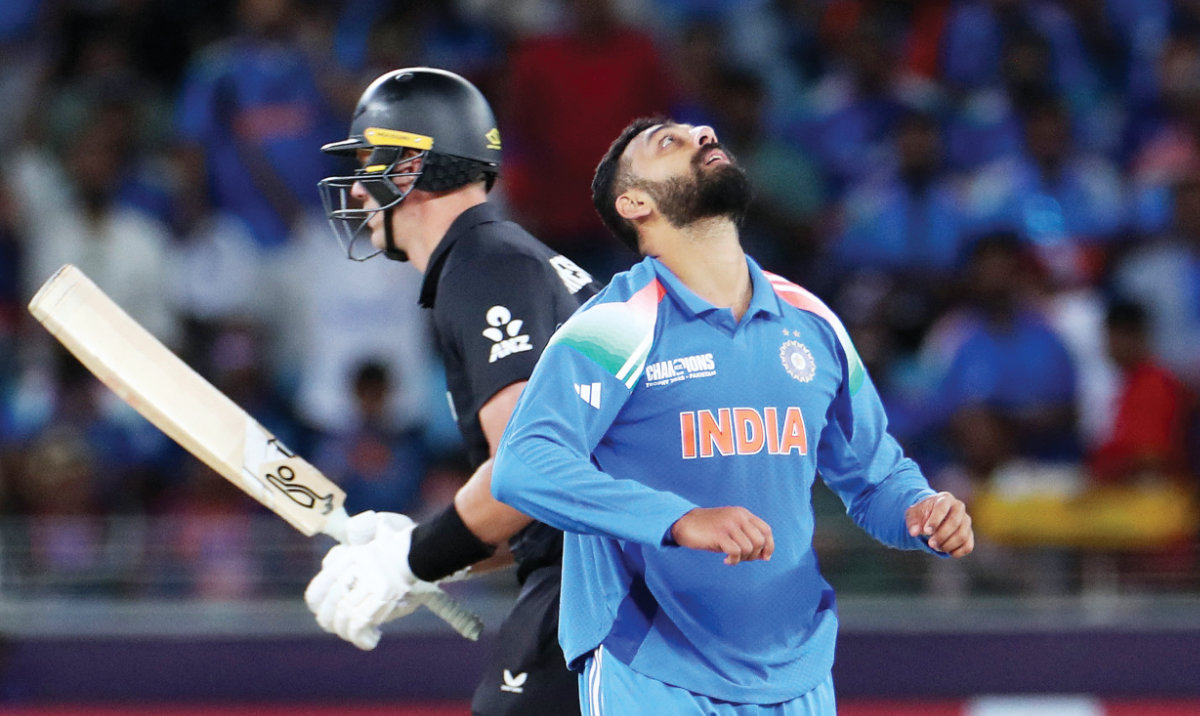 India’s Varun Chakravarthy celebrates after taking the wicket of New Zealand’s Matt Henry during the ICC Champions Trophy cricket match between India and New Zealand at Dubai International Cricket Stadium in Dubai Sunday. (Reuters)