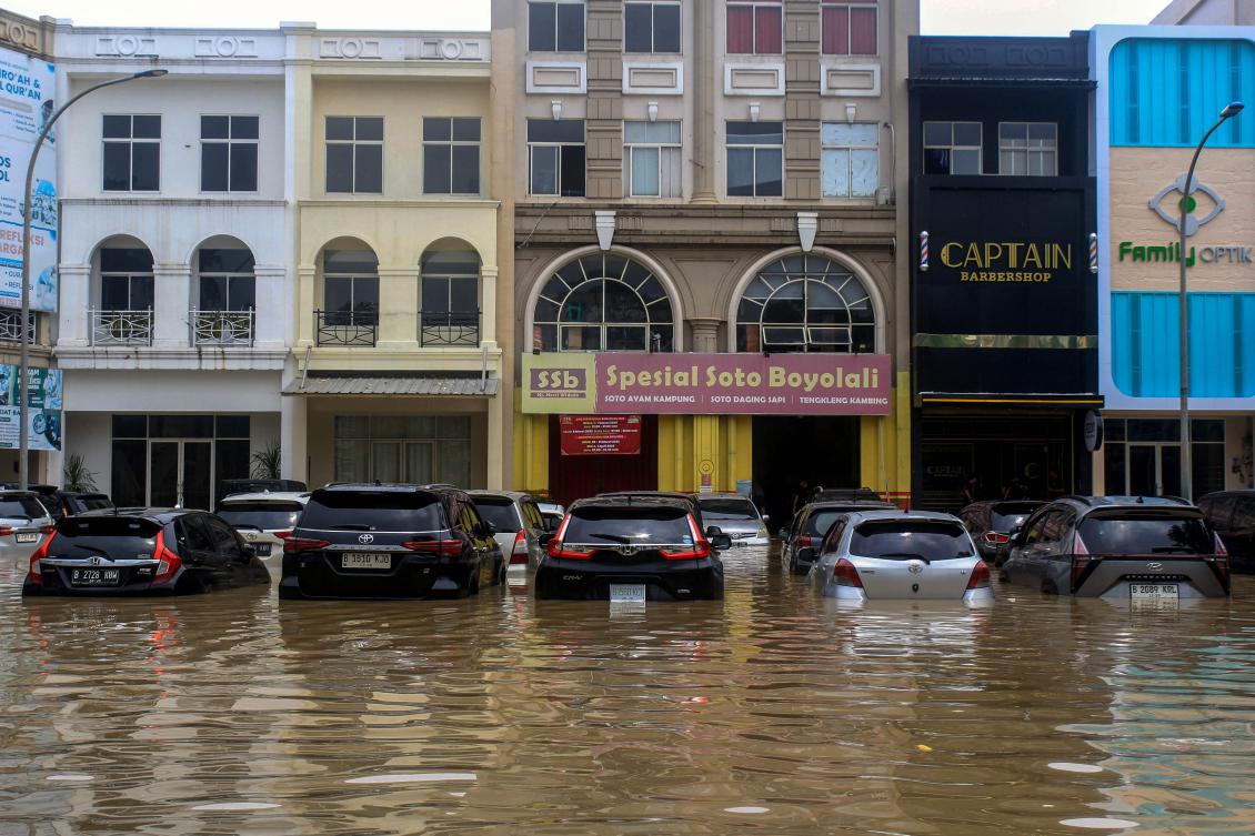 Vehicles are submerged in flood street at the Grand Galaxy Shopping Area in Bekasi, West Java on March 4, 2025. (AFP)