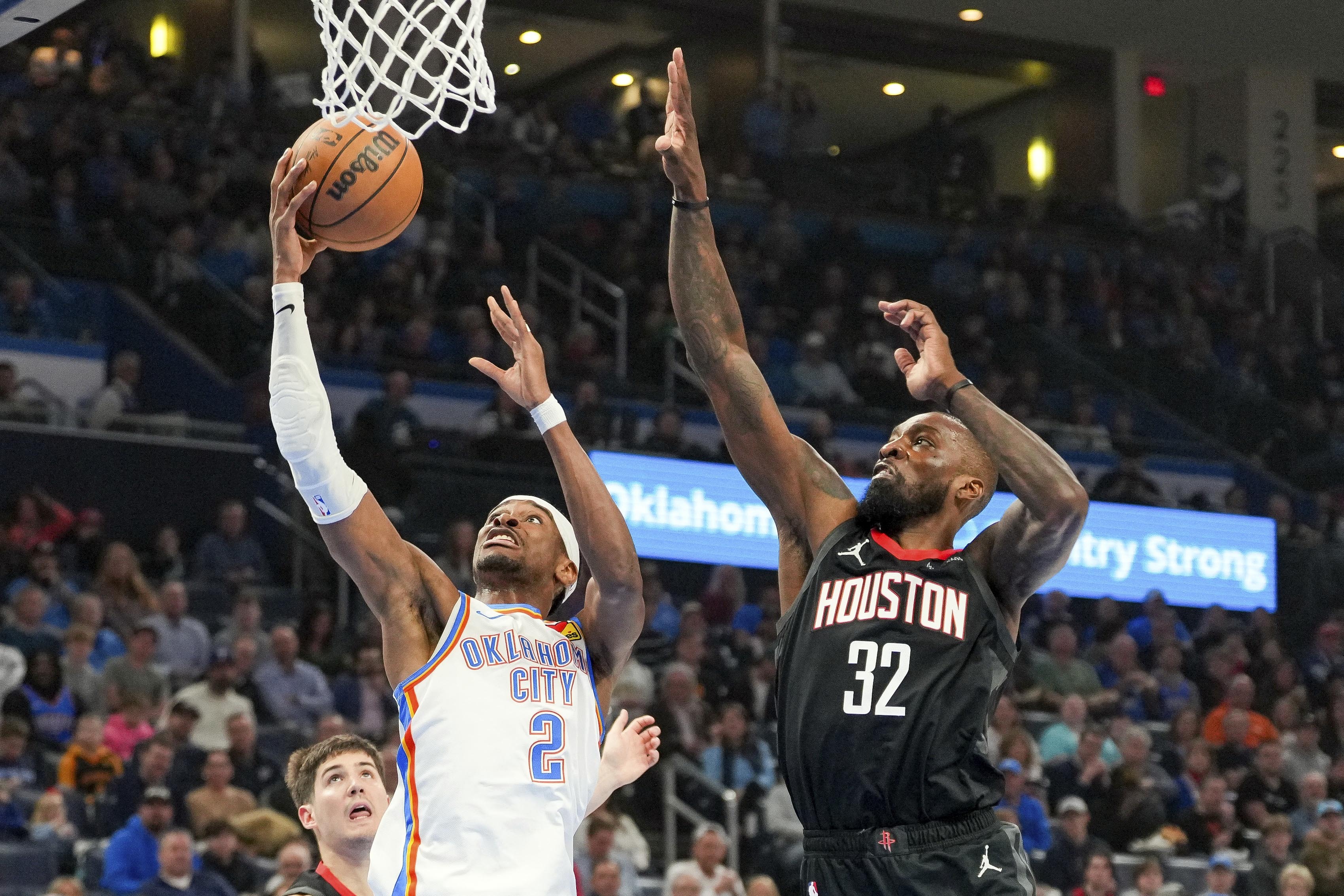 Oklahoma City Thunder guard Shai Gilgeous-Alexander shoots over Houston Rockets forward Jeff Green during the first half of an NBA basketball game Monday in Oklahoma City. (AP)