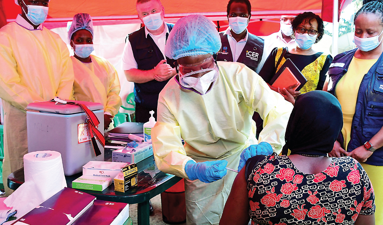A Ugandan doctor vaccinates a patient who tested positive during the launch of the vaccination for the Sudan strain of the Ebola virus at the Mulago Guest House (isolation center) in Kampala. (Reuters)