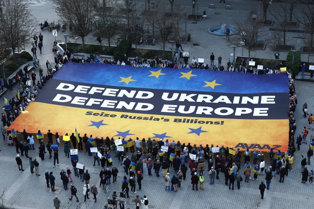 Activists unfurl a large banner in support of Ukraine outside the European Council building ahead of an EU summit in Brussels, Belgium, Wednesday, March 5, 2025. (AP)