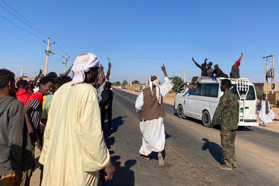 Sudanese people celebrate with passengers of passing vehicles in Meroe in the country's Northern State on January 11, 2025, after the army announced entering key Al-Jazira state capital Wad Madani, held by the paramilitary Rapid Support Forces (RSF). (File/AFP)