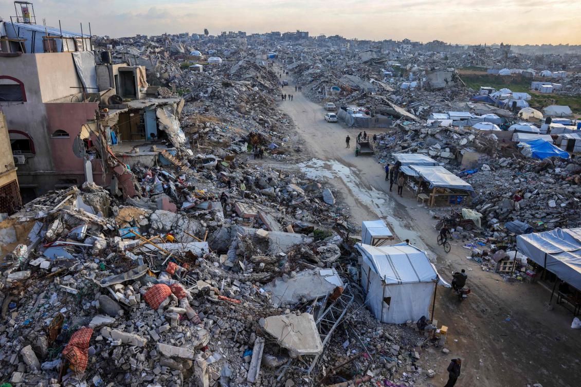Palestinians walk amid the rubble of buildings in Beit Lahia in the northern Gaza Strip on Mar. 4, 2025. (AFP)