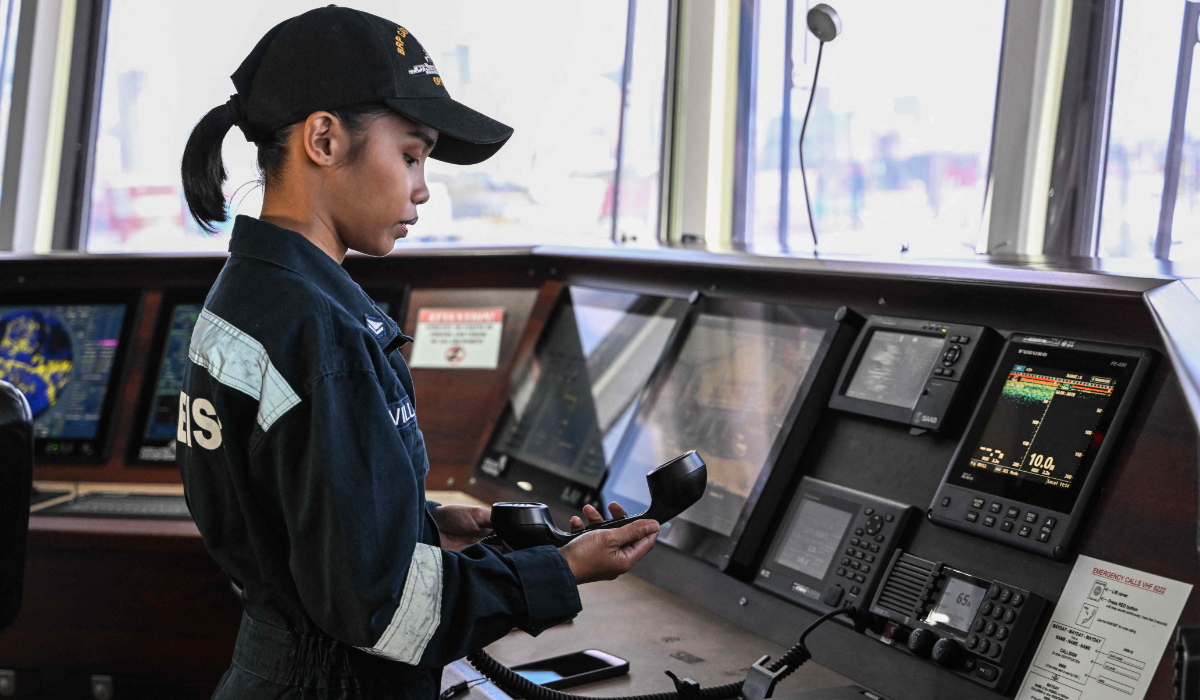 This photo taken on February 28, 2025, shows Stephane Villalon, a Philippine Coast Guard radio operator working with the all-women "Angels of the Sea" programme, demonstrating her work on a ship in Manila. (AFP)