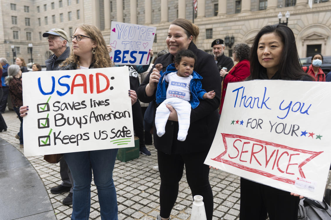 FILE — United States Agency for International Development (USAID) supporters hold banners as USAID workers retrieve their personal belongings from the USAID’s headquarters in Washington, Feb. 27, 2025. (AP)