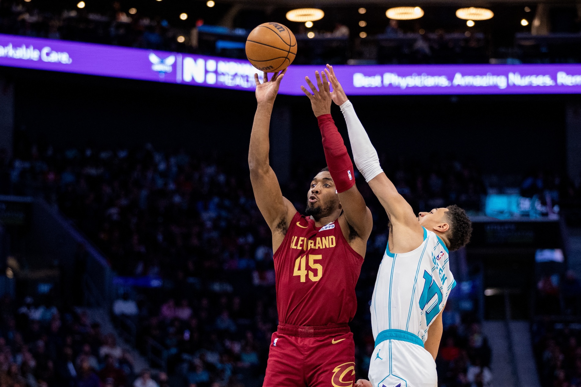 Cleveland Cavaliers guard Donovan Mitchell shoots against Charlotte Hornets guard Josh Green during the fourth quarter of an NBA game at Spectrum Center. (Scott Kinser-Imagn Images)
