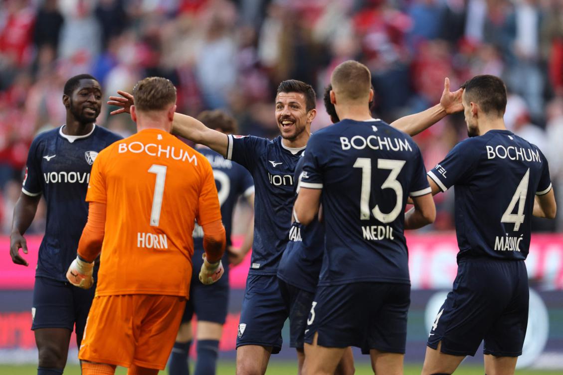 Bochum’s players including German goalkeeper Timo Horn and French midfielder Anthony Losilla celebrate after their Bundesliga match against Bayern Munich in Munich, on Mar. 8, 2025. (AFP)