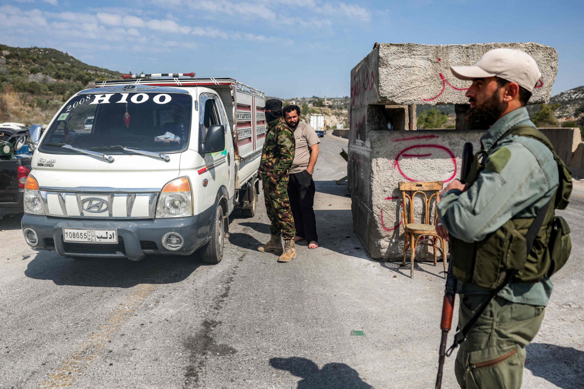 Security forces loyal to the interim Syrian government stop a vehicle for inspection at a checkpoint in Syria's western city of Latakia on March 9, 2025. (AFP)