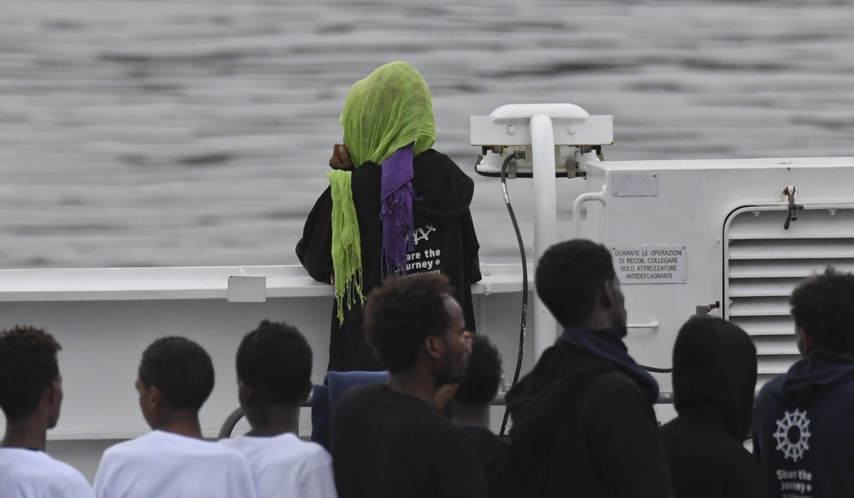 Migrants stand on the deck of the Italian Coast Guard ship Diciotti, moored at the Catania harbor, Tuesday, Aug. 21, 2018. (AP)