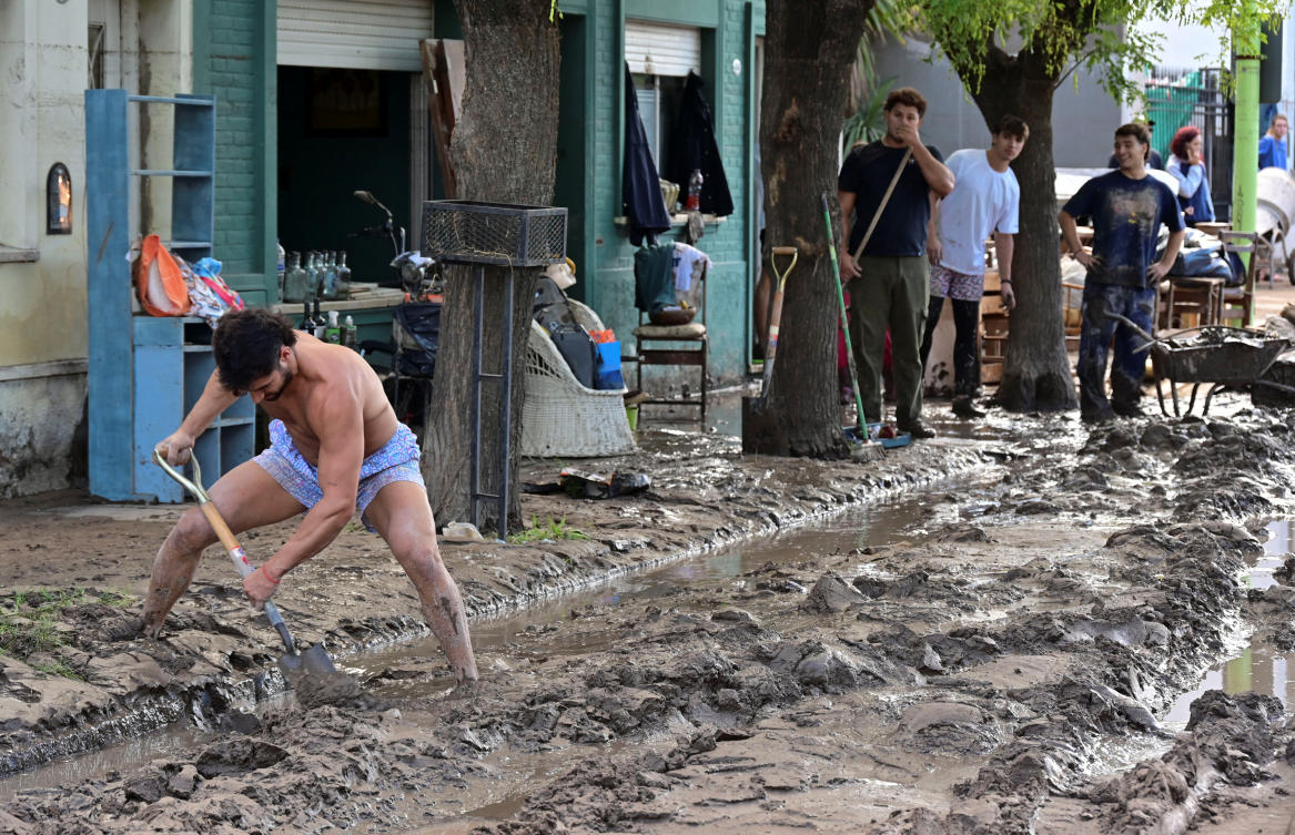 A man uses a shovel to clean the street after a flooding struck the city of Bahia Blanca, in Buenos Aires, Argentina on March 8, 2025. (Reuters)