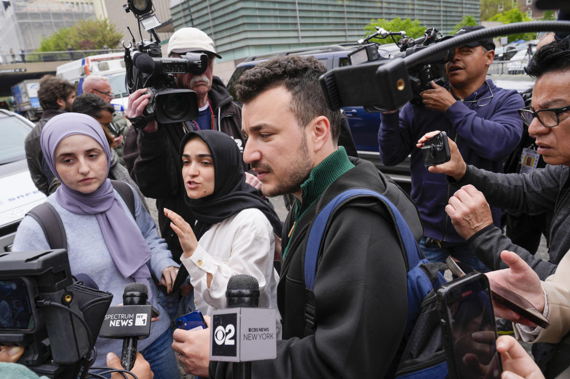 Members of the Columbia University Apartheid Divest group, including Sueda Polat, second from left, and Mahmoud Khalil, (C), are surrounded by members of the media outside the Columbia University campus. (File/AP)