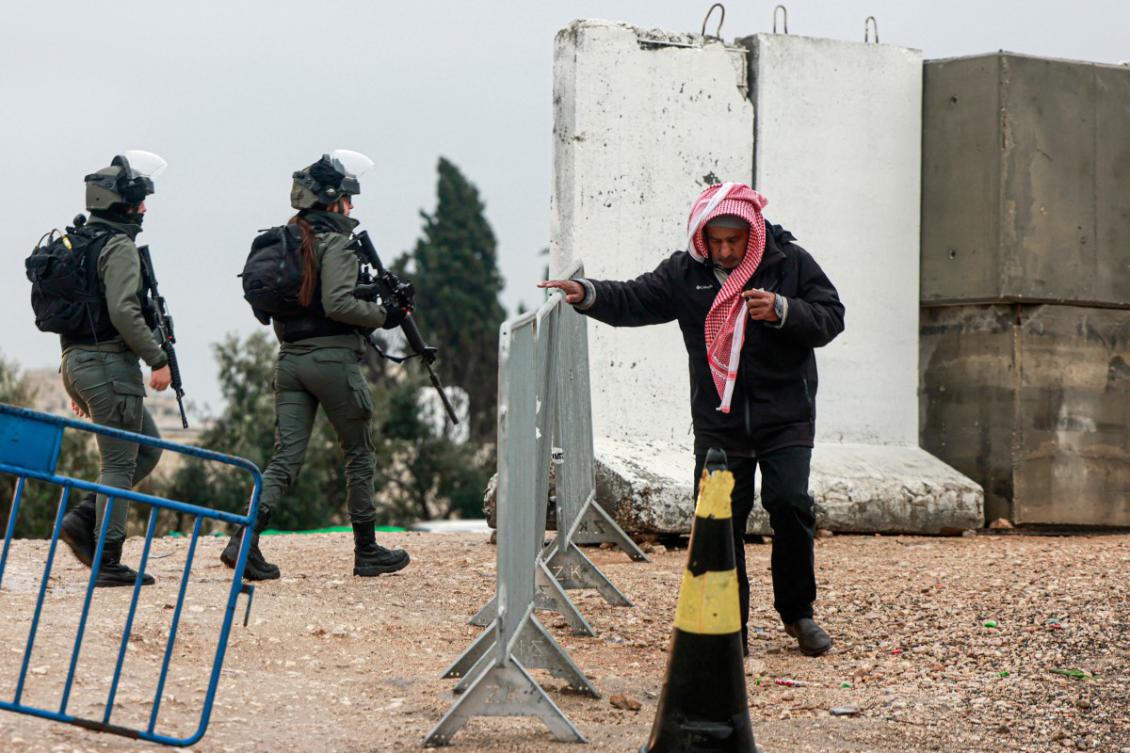 A Palestinian Muslim worshipper crosses an Israeli army checkpoint in Qalandia in the occupied West Bank to attend the first Friday prayers of the fasting month of Ramadan at the Al-Aqsa mosque compound in east Jerusalem, on March 7, 2025. (AFP)