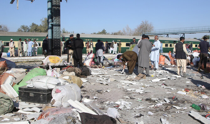 Plain-clothed police officers survey the site amid the debris after a bomb blast at a railway station in Quetta in 2024. (Reuters/File)