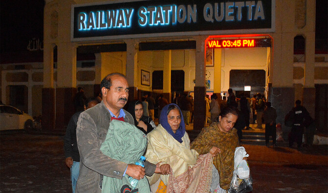 Passengers who were rescued from a train after it was attacked by separatist militants, walk with their belongings at the Railway Station in Quetta, Balochistan, Pakistan, on March 12, 2025. (REUTERS)