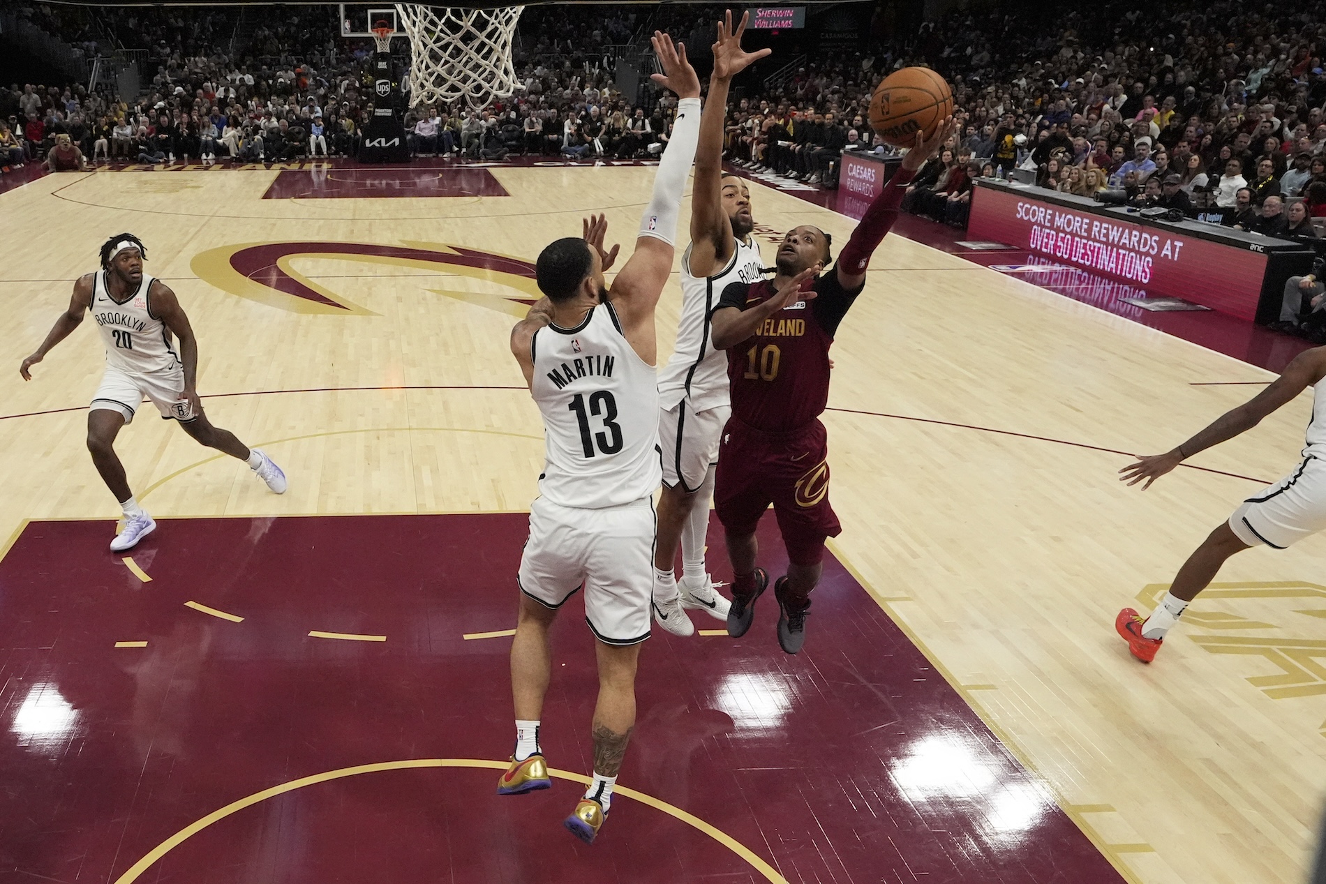 Cleveland Cavaliers guard Darius Garland shoots as Brooklyn Nets guard Tyrese Martin (13) and forward Trendon Watford, center, defend in the second half of an NBA basketball game Tuesday in Cleveland. (AP)
