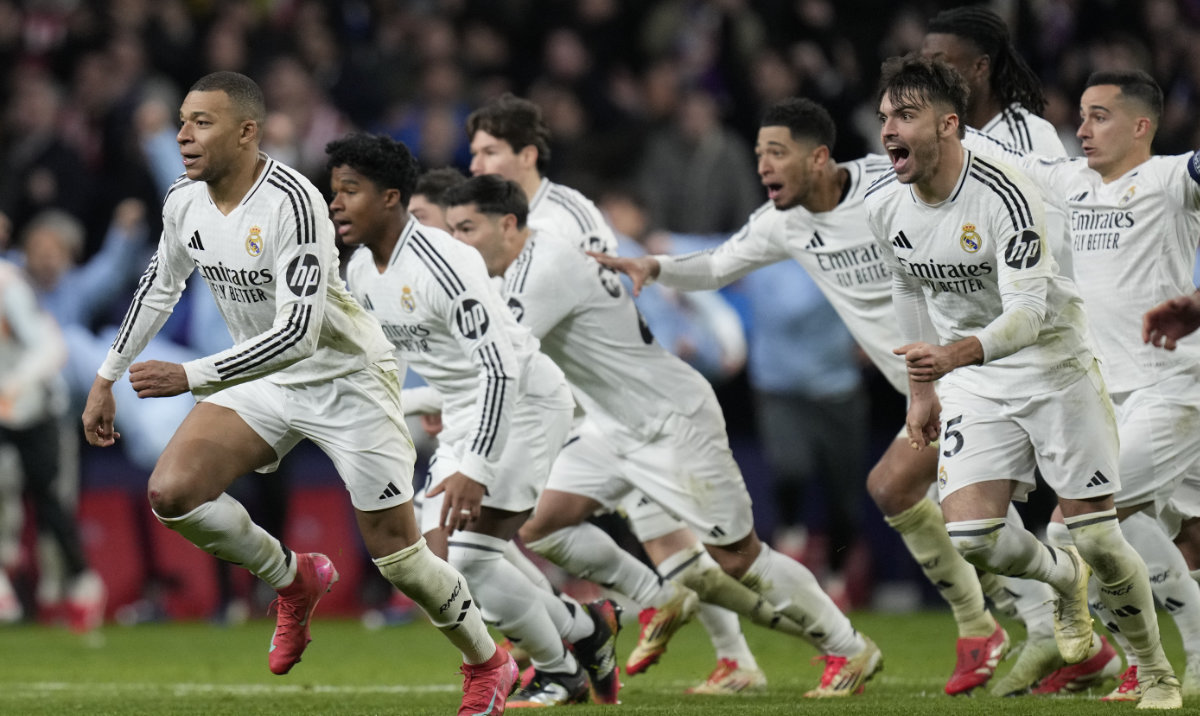 Real Madrid players celebrate after winning the penalty shootout during the Champions League round of 16, second leg, soccer match between Atletico Madrid and Real Madrid at the Metropolitano stadium in Madrid, Spain, Wednesday, March 12, 2025. (AP)