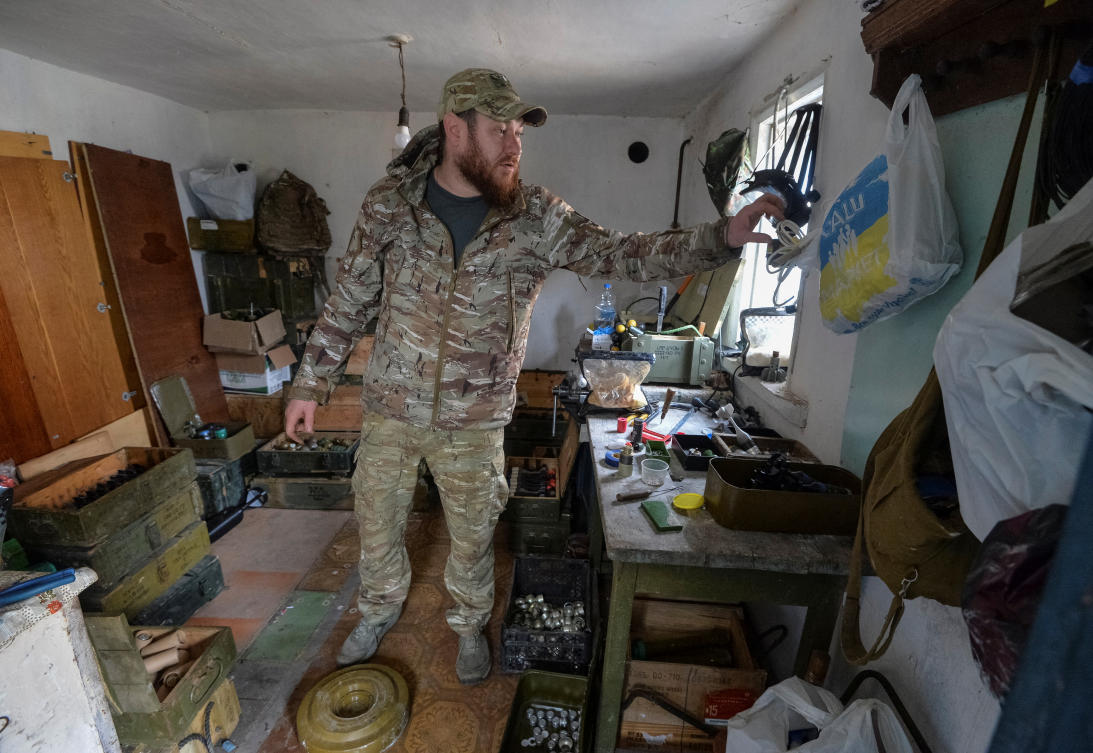 A Ukrainian serviceman prepares a bomb for a combat drone made from an anti-tank mine near the frontline in the Kharkiv region on March 13, 2025. (Reuters)