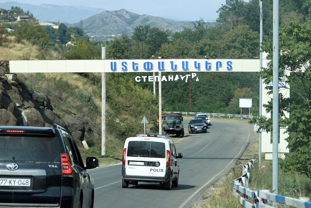 Above, the damaged entrance sign of Stepanakert city, known as Khankendi by Azerbaijan on Oct. 2, 2023. (Reuters)