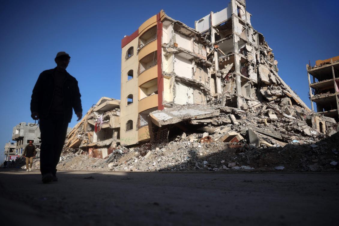 Palestinians walk in a war-devastated neighbourhood in the Nuseirat refugee camp in the central Gaza Strip on March 14, 2025. (AFP)